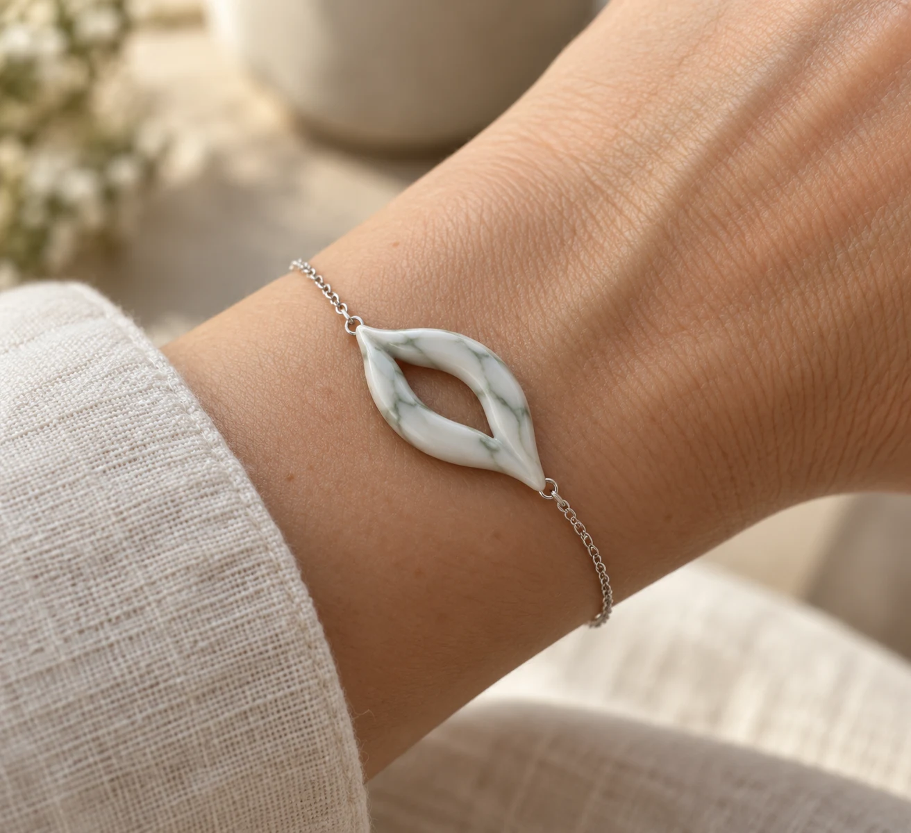 White marble-effect open leaf bracelet with sage veins on a wrist